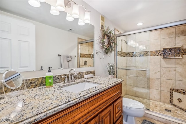 bathroom with vanity, toilet, and walk in shower