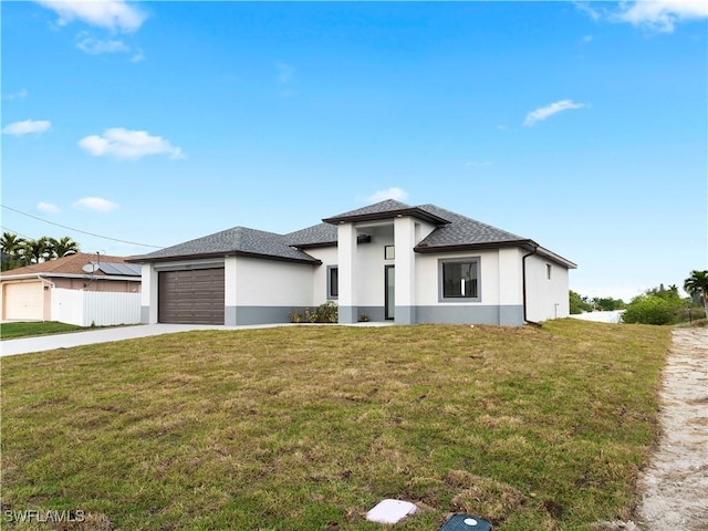 view of front of home featuring a front yard and a garage