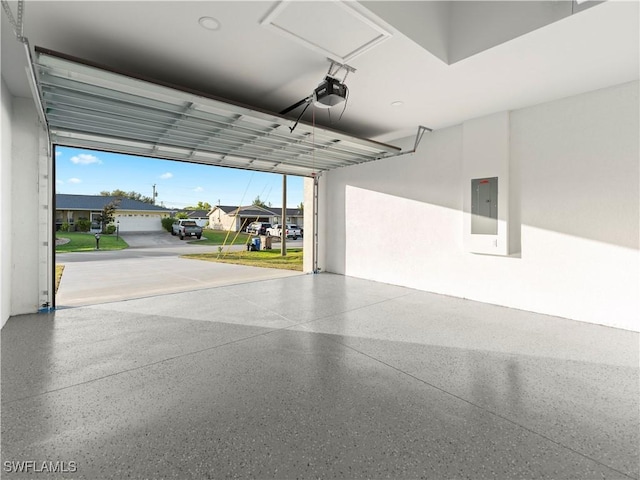 garage with electric panel and a garage door opener