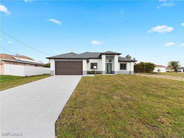 prairie-style home with a front lawn and a garage