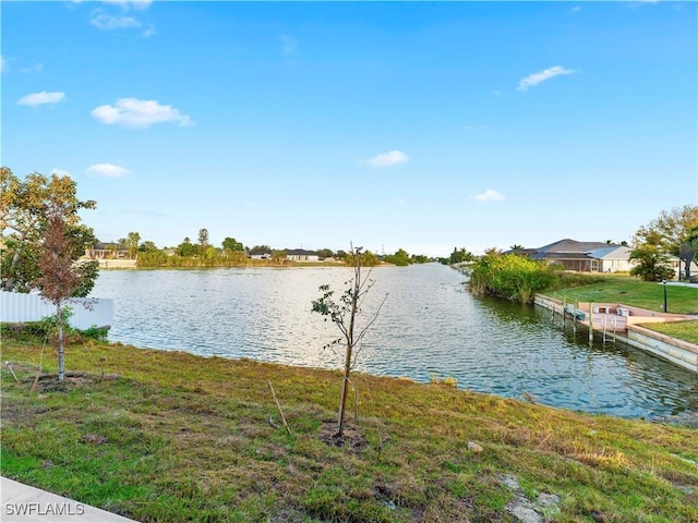 dock area featuring a yard and a water view