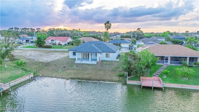 aerial view at dusk with a water view