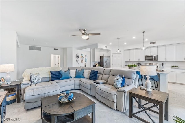 tiled living room with ceiling fan