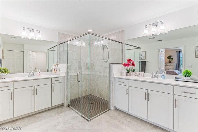 bathroom with tile patterned floors, vanity, and an enclosed shower