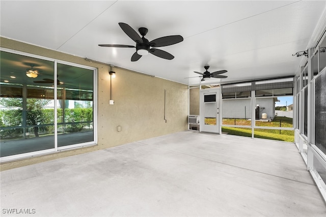 unfurnished sunroom with a wall unit AC