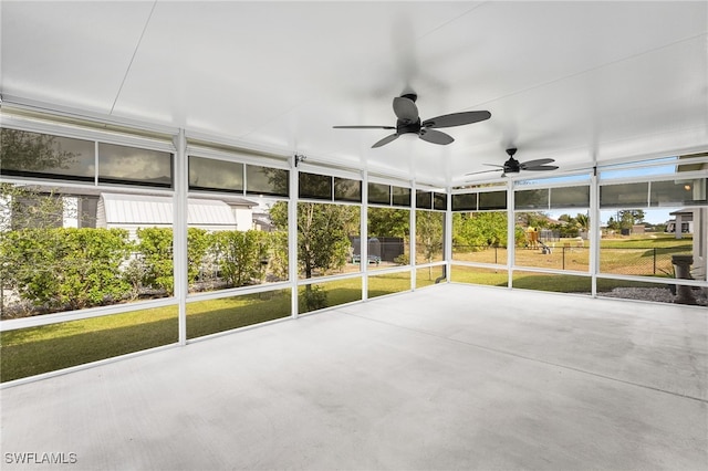 unfurnished sunroom featuring ceiling fan