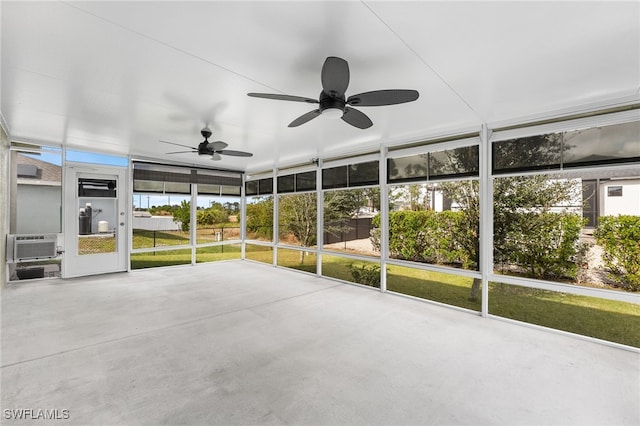 unfurnished sunroom featuring ceiling fan and cooling unit