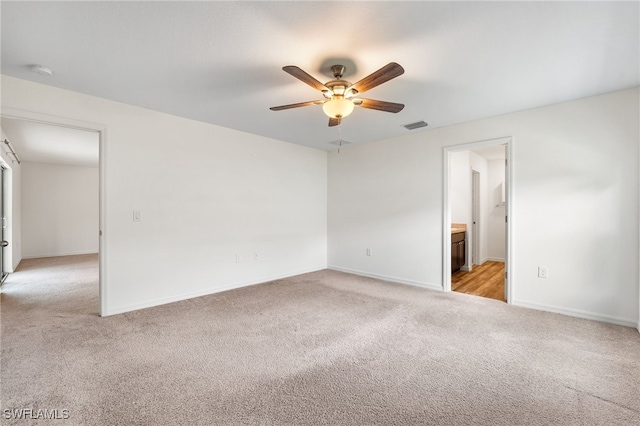 spare room with light carpet and ceiling fan