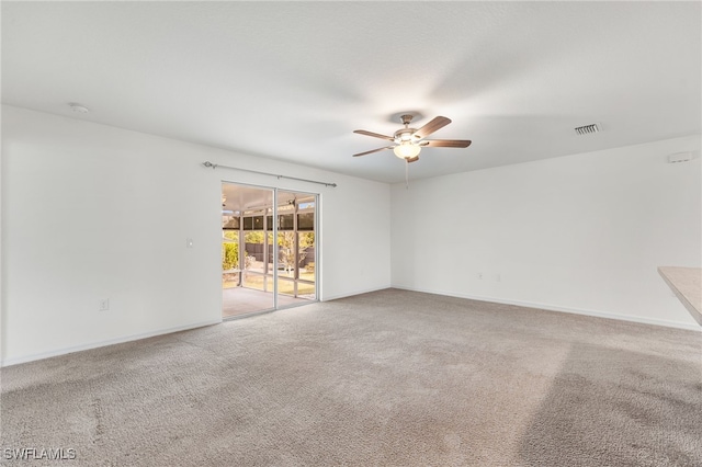 spare room with ceiling fan and carpet floors