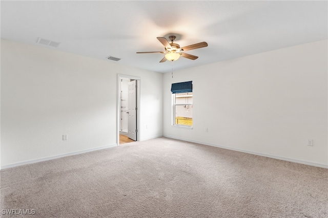 unfurnished room featuring ceiling fan and light colored carpet