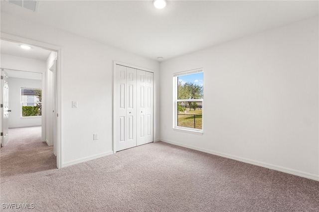 unfurnished bedroom with a closet and carpet floors