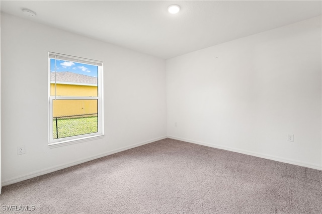 carpeted empty room featuring a wealth of natural light