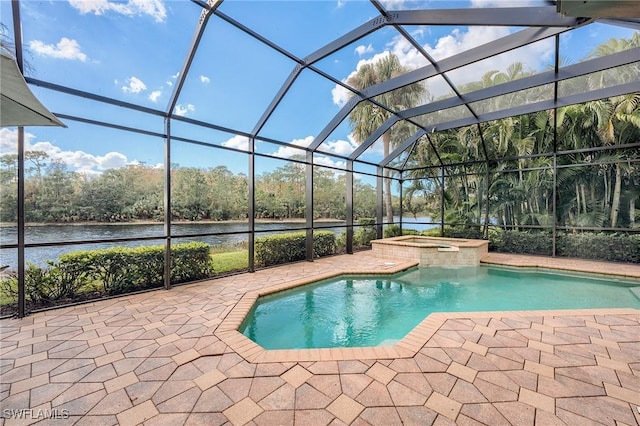 view of pool featuring a lanai, a patio area, a water view, and an in ground hot tub