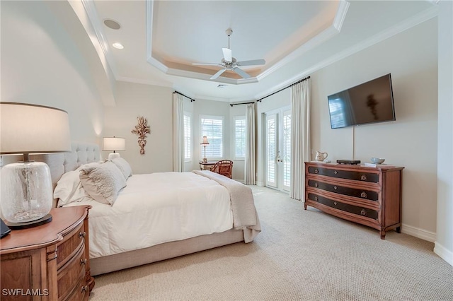 bedroom featuring access to exterior, ceiling fan, crown molding, light colored carpet, and a tray ceiling