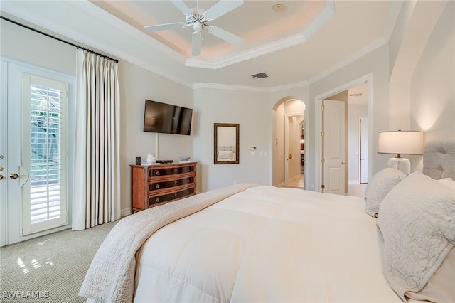 carpeted bedroom with a raised ceiling, access to exterior, ceiling fan, and crown molding