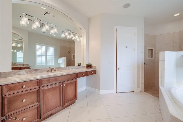 bathroom with shower with separate bathtub, vanity, and tile patterned floors