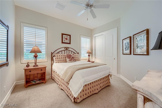 carpeted bedroom featuring ceiling fan and a closet