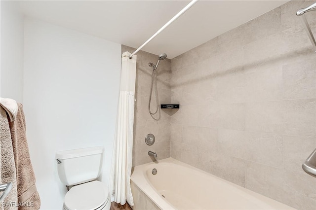 bathroom with toilet and shower / bath combo with shower curtain