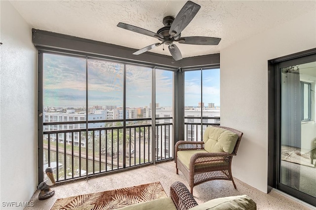 sunroom / solarium featuring a wealth of natural light and ceiling fan