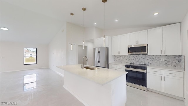 kitchen featuring pendant lighting, stainless steel appliances, white cabinetry, and a center island with sink