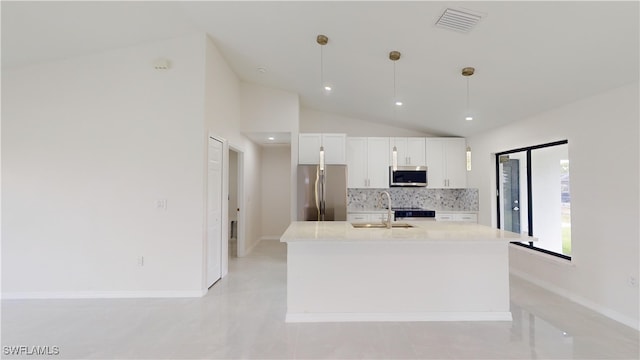 kitchen featuring decorative backsplash, appliances with stainless steel finishes, sink, pendant lighting, and white cabinetry