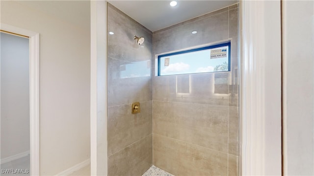 bathroom with tiled shower