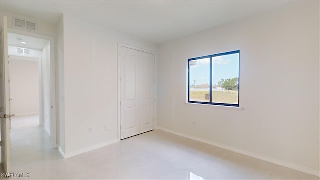 unfurnished bedroom with a closet