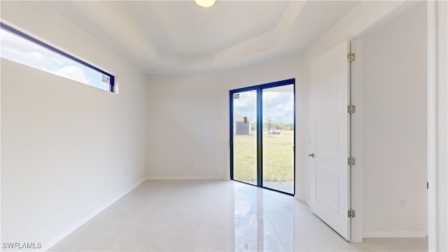 spare room featuring a raised ceiling