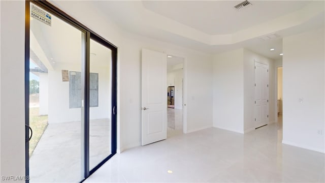 spare room with a raised ceiling