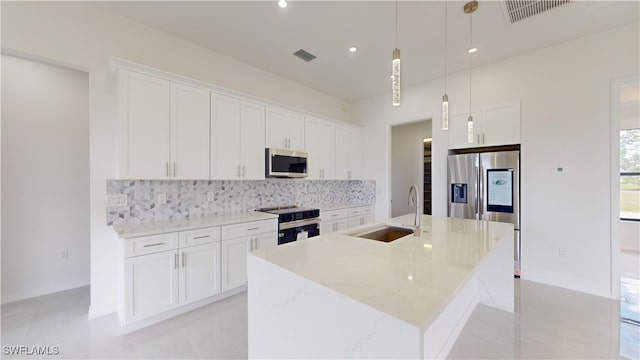 kitchen with sink, stainless steel appliances, and white cabinets