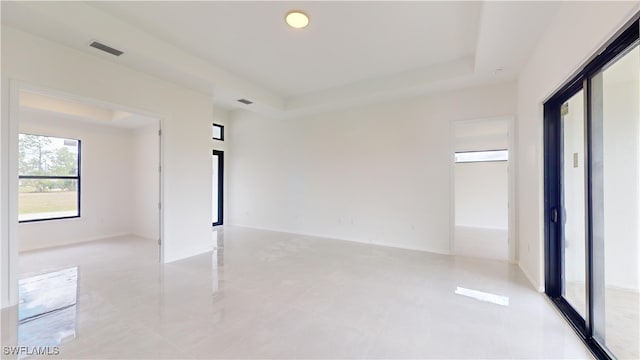 empty room featuring a tray ceiling