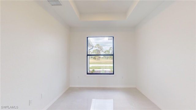 unfurnished room with a tray ceiling