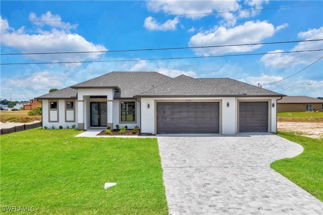 view of front of home with a garage and a front lawn