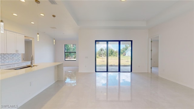 unfurnished living room with sink