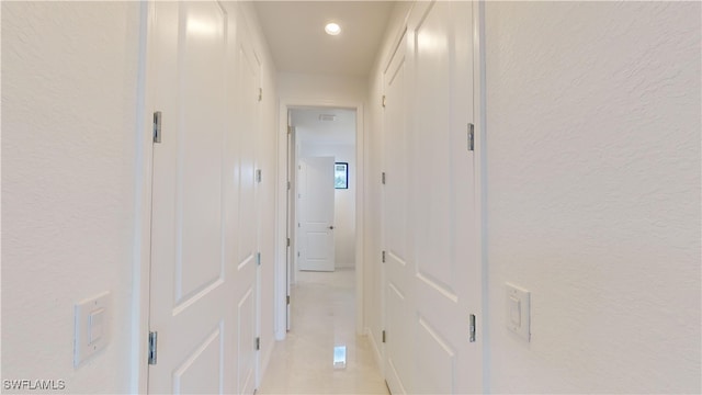 hall with light tile patterned floors