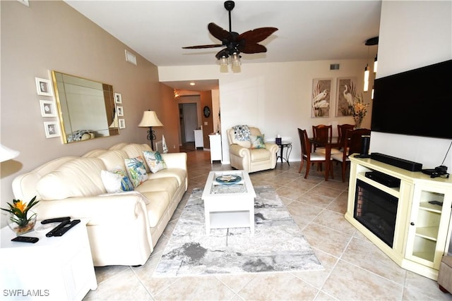 living room featuring light tile patterned floors and ceiling fan