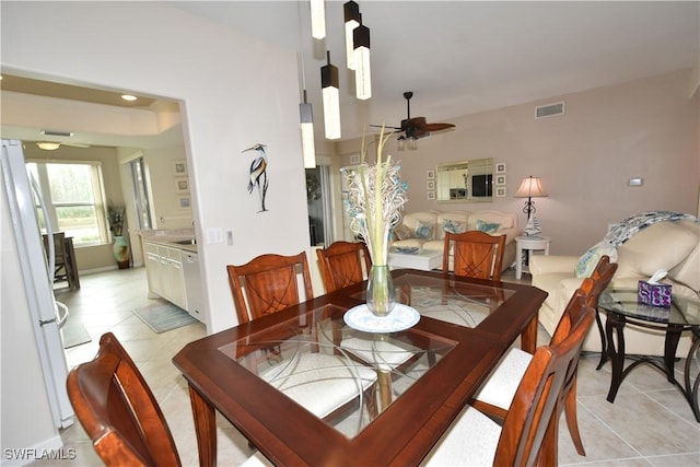 tiled dining area with ceiling fan