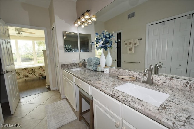 bathroom featuring tile patterned flooring, vanity, and ceiling fan