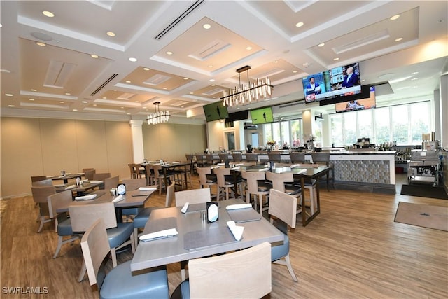 dining room featuring hardwood / wood-style floors, beamed ceiling, and coffered ceiling