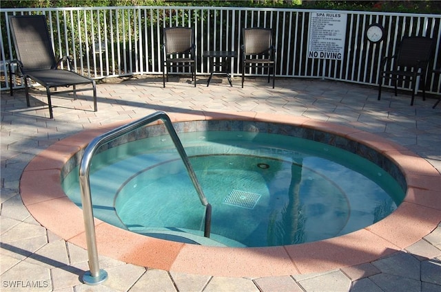 view of pool with a hot tub