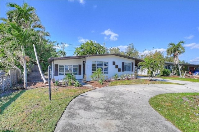 single story home featuring a carport and a front lawn