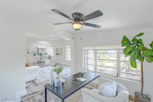 living room featuring ceiling fan and light wood-type flooring