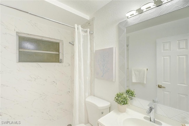 bathroom featuring vanity, a shower with shower curtain, and toilet