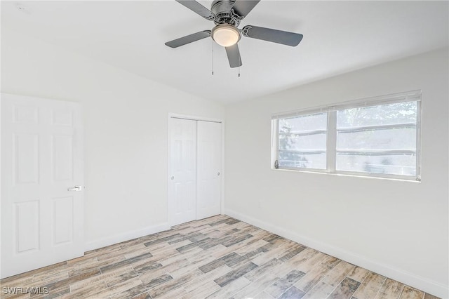 empty room featuring ceiling fan and light hardwood / wood-style floors