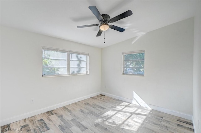 spare room with light hardwood / wood-style flooring and ceiling fan