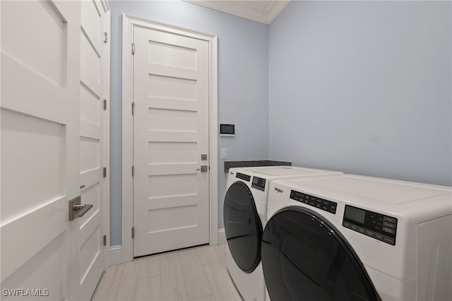 laundry area featuring separate washer and dryer and crown molding