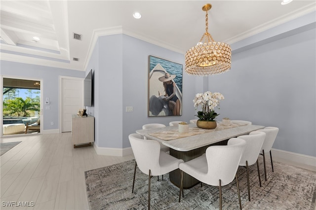 dining area featuring a chandelier and crown molding