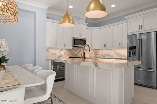 kitchen featuring white cabinets, appliances with stainless steel finishes, and tasteful backsplash