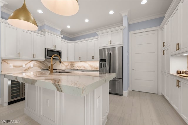 kitchen with stainless steel appliances, tasteful backsplash, wine cooler, decorative light fixtures, and ornamental molding