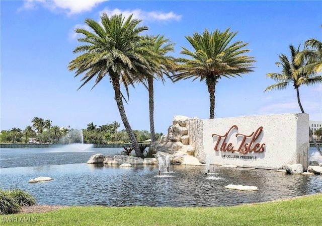 community / neighborhood sign with a water view